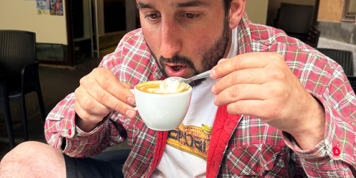 Man stirring cappuccino